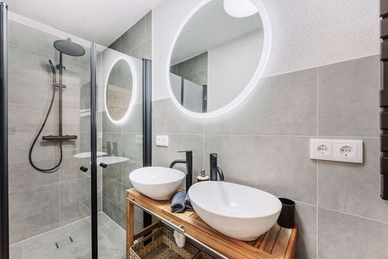 Bathroom with shower and double sink in apartment 2